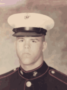 a man in a military uniform with a white hat