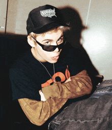 a young man wearing sunglasses and a hat that says turbo summerslam