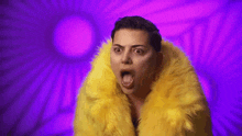 a woman in a yellow fur coat is making a funny face with her mouth open .