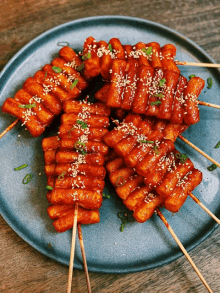 a plate of food with sesame seeds and green onions on top