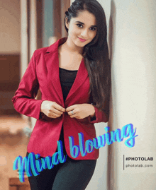 a woman in a red jacket is leaning against a wall with the words mind blowing written on it