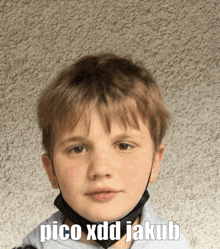 a young boy wearing a mask with the words pico xdd jakub written on the bottom