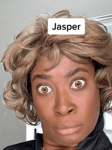 a woman wearing a wig has the name jasper on her face