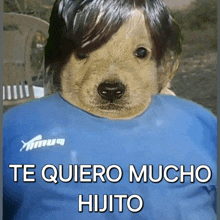 a dog wearing a blue shirt with the words te quiero mucho hijito