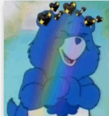 a blue care bear with a crown of hearts on its head is sitting in front of a rainbow .