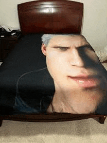 a bed with a blanket with a man 's face on it .