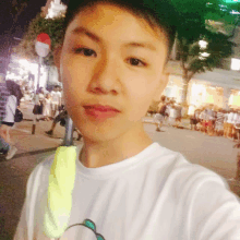 a young man taking a selfie in front of a no entry sign