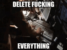 a person is typing on a keyboard with the words delete fucking everything .