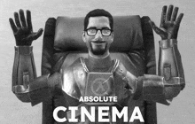 a black and white photo of a man sitting in a chair with the words absolute cinema above him