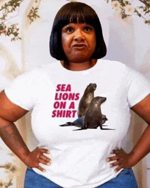 a woman wearing a t-shirt that says `` sea lions on a shirt '' .