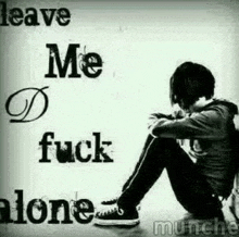 a black and white photo of a boy sitting on the floor with the words `` leave me alone '' written above him .