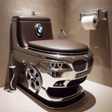 a toilet in the shape of a bmw with a bmw logo on it