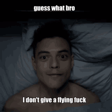 a shirtless man laying in bed with a caption that says guess what bro i don t give a flying fuck