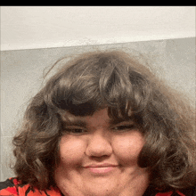 a close up of a person 's face with curly hair