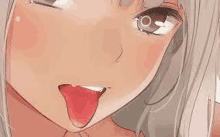 a close up of a girl 's face with her tongue sticking out .