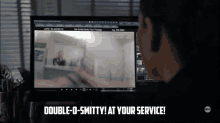 a man sitting in front of a computer with the words double g-smtty at your service