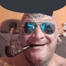 a man wearing sunglasses and smoking a pipe is smiling .