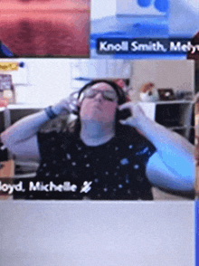 a woman wearing headphones with the name knoll smith on the screen