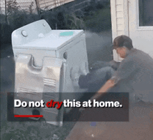 a man standing next to a washer and dryer with the words do not dry this at home below him