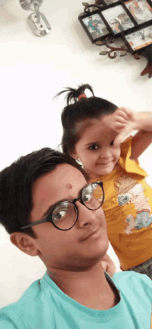 a boy wearing glasses and a girl wearing a shirt that says ' i love you '