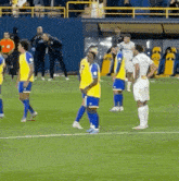 a group of soccer players are standing on a field and one of them has the number 7 on his shirt