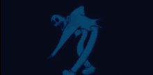 a cartoon character is standing in the dark and glowing blue .