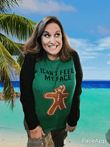 a woman wearing a green sweater that says ' i can 't feel my face '