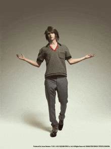 a man in a sweater and pants is standing with his hands outstretched