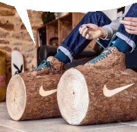 a person wearing a pair of shoes made out of logs with a nike logo on them