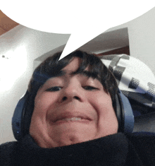 a young boy wearing headphones has a speech bubble over his head