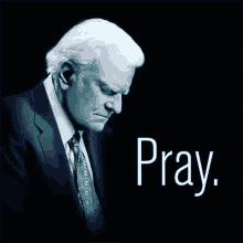 an older man in a suit and tie is praying .