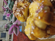 a bunch of bread sitting on a table next to a plant