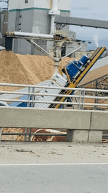 a fenced in area with a conveyor belt going through it