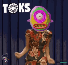 a woman in a floral dress has a colorful mask on her head and the word tok 's on the bottom