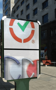 a billboard with a red circle with a green check mark and the letter r on it