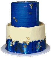 a blue and white cake with gold foil on top