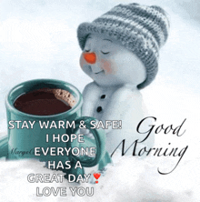 a snowman wearing a hat is holding a cup of coffee and says good morning