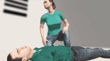 a woman in a green shirt is kneeling over a man laying on the floor