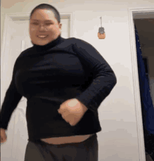 a man wearing a black turtleneck sweater is dancing