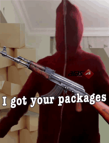 a man in a red alaska hoodie is holding a rifle