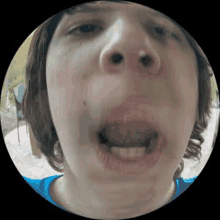 a close up of a person 's face with their tongue sticking out .