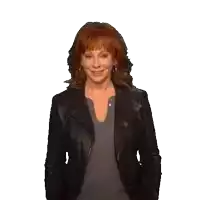 a woman with red hair is wearing a leather jacket