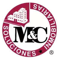 a logo for m & c inmobiliarias with a building in the middle