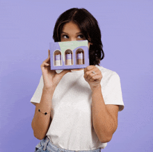 a woman in a white shirt holds a box that says florence