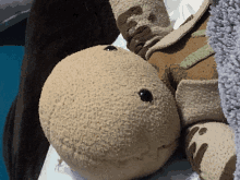 a close up of a stuffed animal laying on a blanket