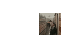 a woman is standing on a balcony in the rain holding a umbrella .