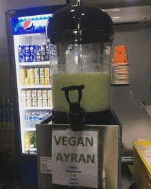 a dispenser that says vegan ayran on it