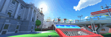 a blurred image of a city with buildings and a red fence