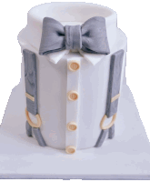 a white cake with a bow tie and suspenders