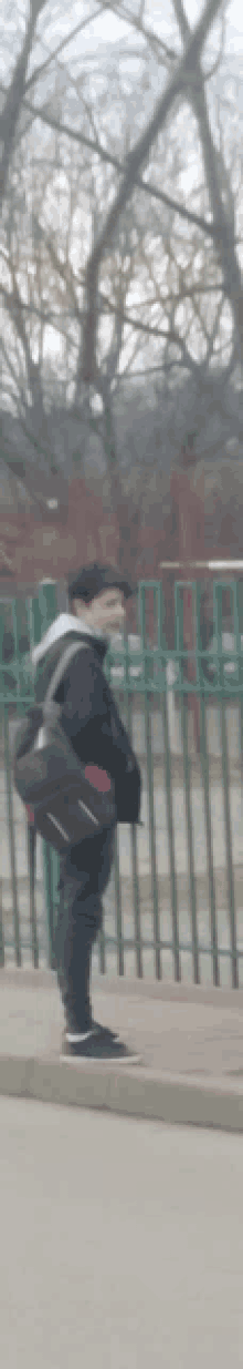 a blurry picture of a person walking on a sidewalk with a backpack